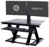 2 monitors on a black standing desk