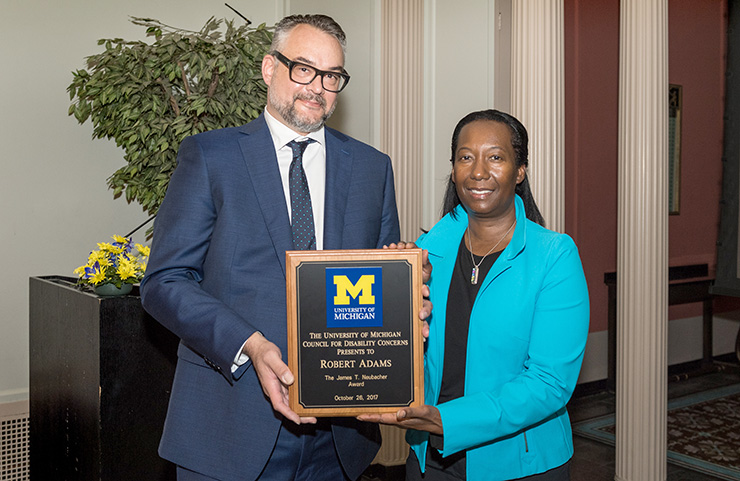 Regent Katherine White presents Robert Adams, associate professor of architecture and of art and design, with the 28th annual James T. Neubacher Award.