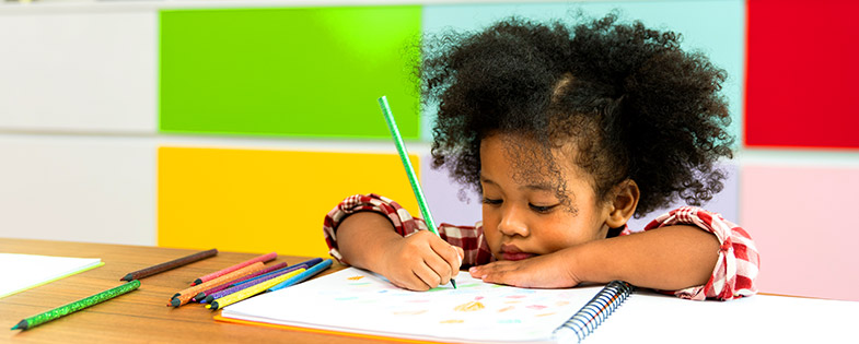 Girl coloring in colorful room