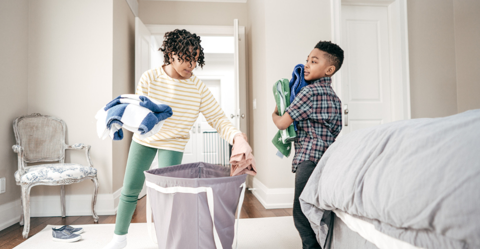 Two kids folding laundry