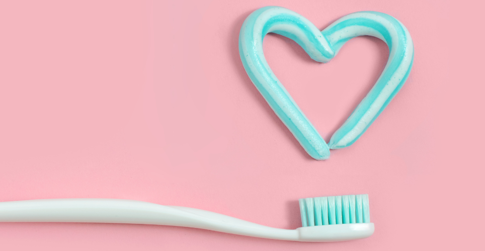 Toothbrush with toothpaste in the shape of a heart. 