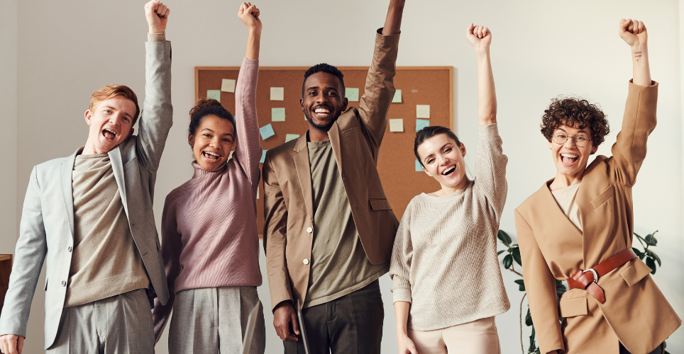 Group of coworkers with their fists high in the air