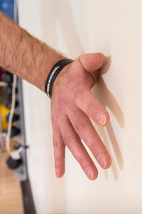 close up of a person's hand on the wall