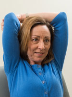 Woman with arms behind her head