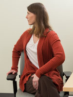 Woman turning body to the left while sitting