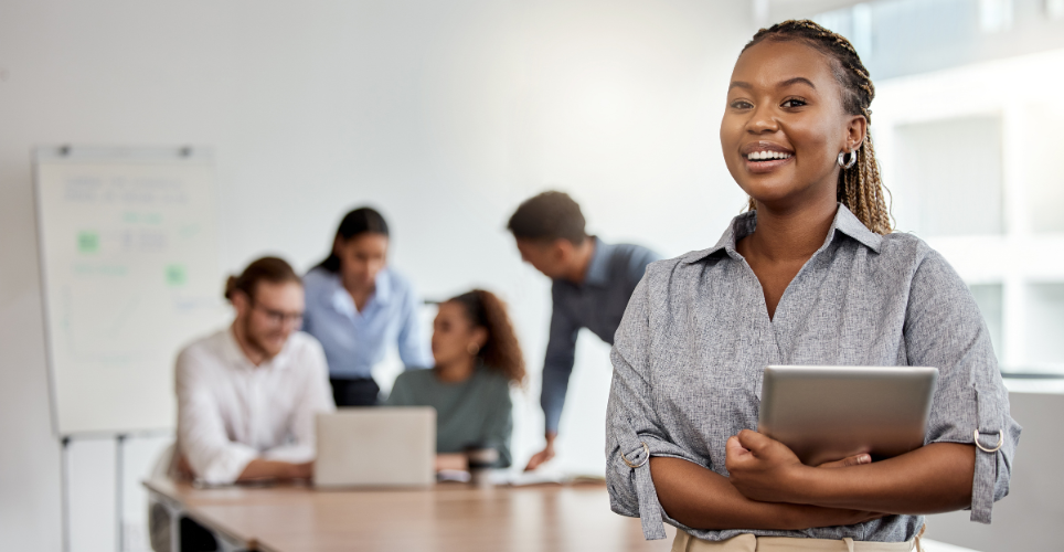 Woman standing in a room with her peers