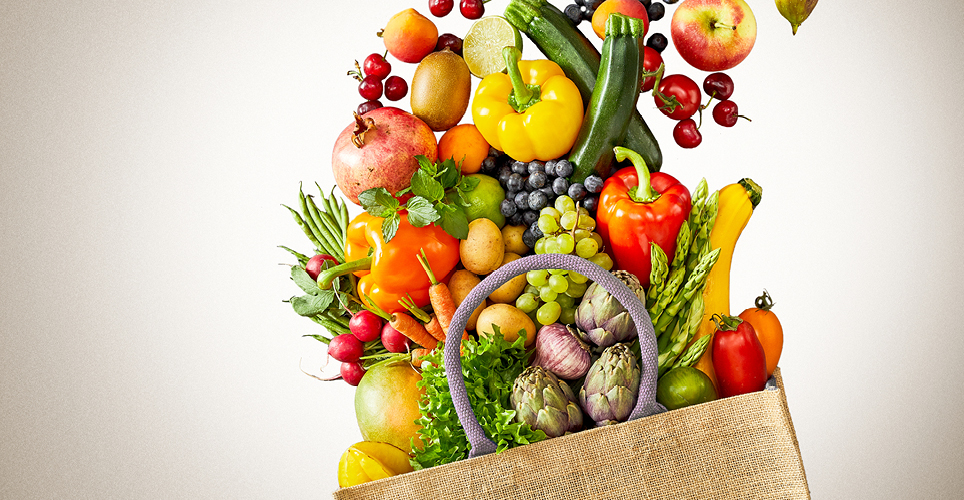 Grocery bag full of fresh fruits and vegetables