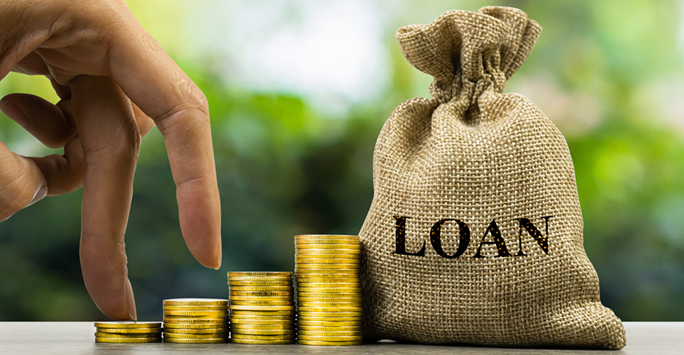hand on stack of coins, canvas bag labeled "loan"