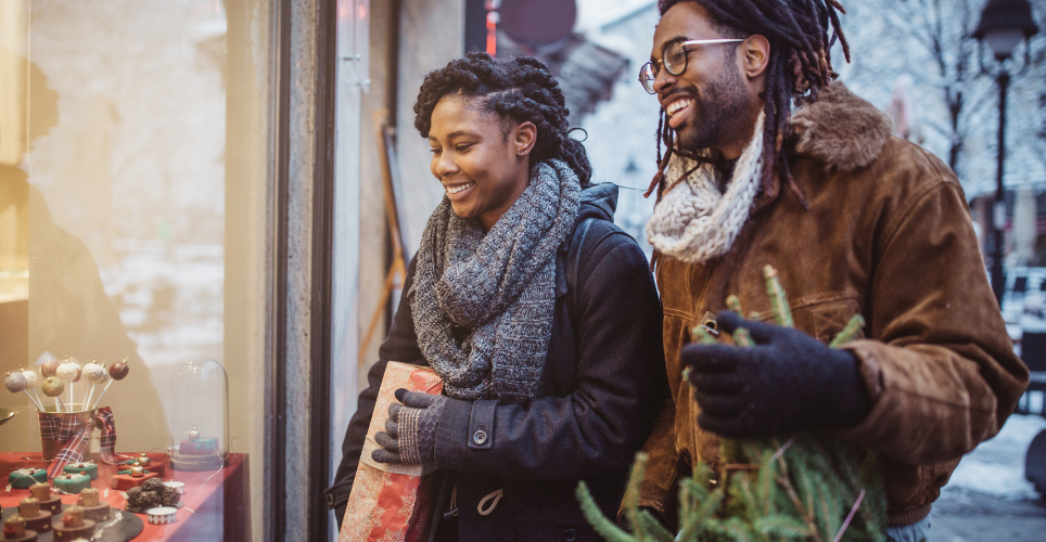 Two people holiday shopping with big smiles