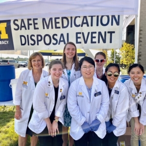 College of Pharmacy students at a Safe Medication Disposal Event collection tent.