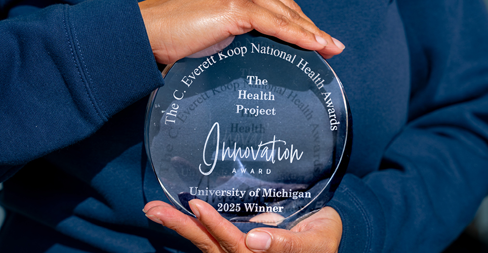 hands holding the Koop Innovation Award 