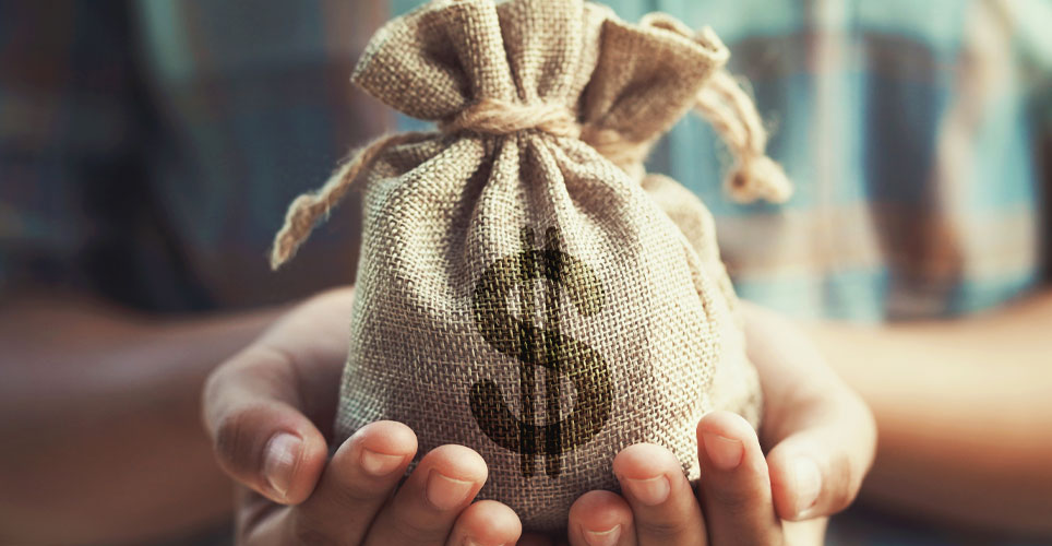 Close up of two Black hands holding a burlap bag with a dollar sign on it.