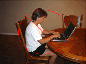 bent neck and back using a laptop