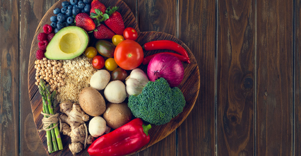 fresh vegetables in a heart shaped bowl