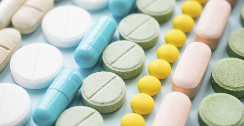 close of up colorful pills and tablets in round and oblong shapes