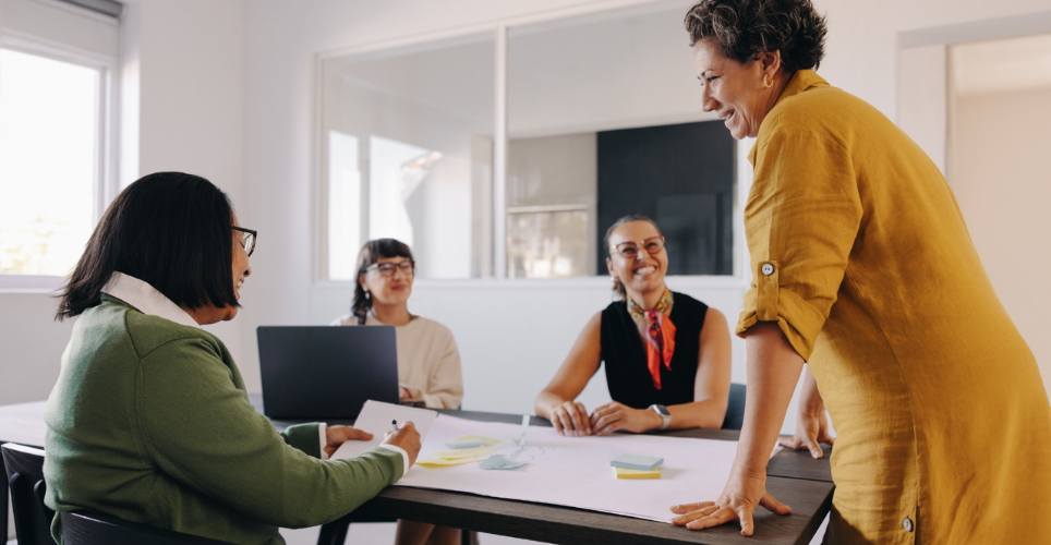 colleagues in a bright office meeting around a table