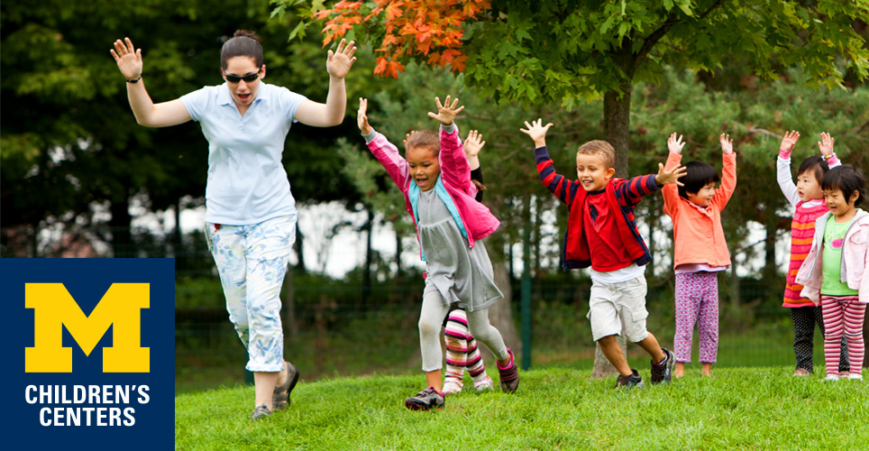 Children and teacher playing outside the North Campus Children's Center