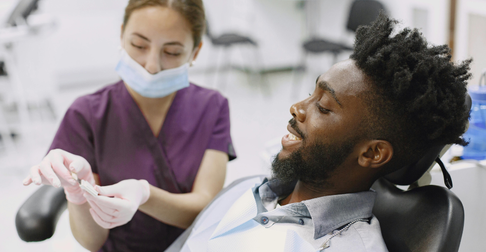 Man sitting in a dentists chair getting a check up