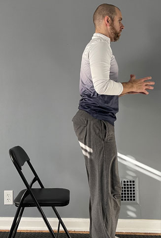 man standing in front of chair