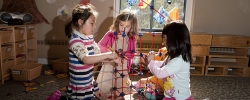 Young girls building a construction project indoors