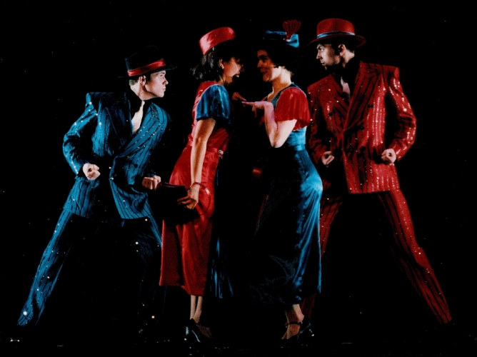 Four people dancing in costumes 