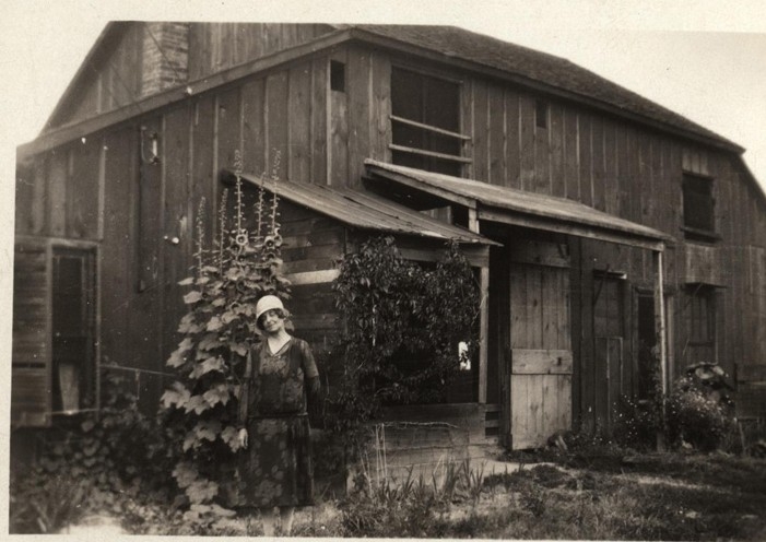 Agnes Inglis standing in front of barn at Inglis Farm