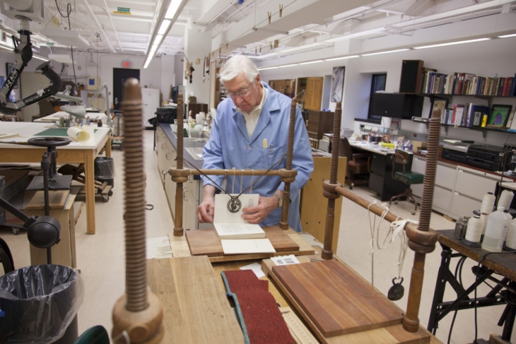 Jim Craven works on a rare book in the Michigan Historical Collections in the Bentley Library
