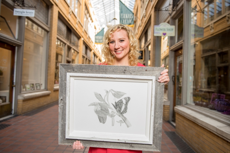 Jessica Bennett holding framed artwork
