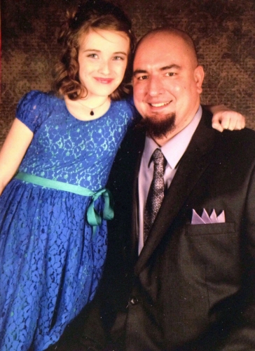 John Miller with his daughters arm around him
