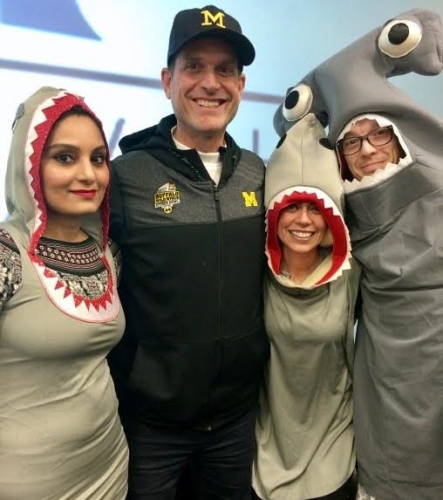 Mediha Ibrahim, Denise Lassaline and Casey Cox dressed as sharks with Jim Harbaugh