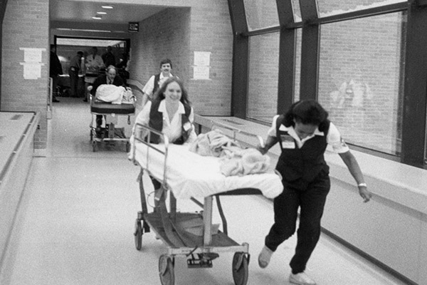 Staff moving patients into the new hospital