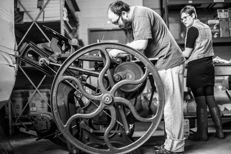 Fritz Swanson operating the circa 1900 Chandler & Price letterpress with Mary Camille Beckman