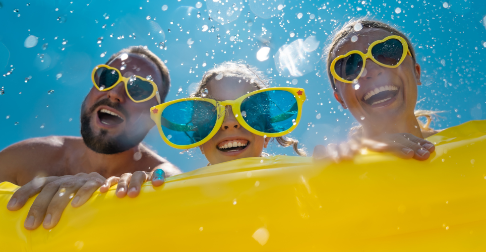 Family smiling in the water