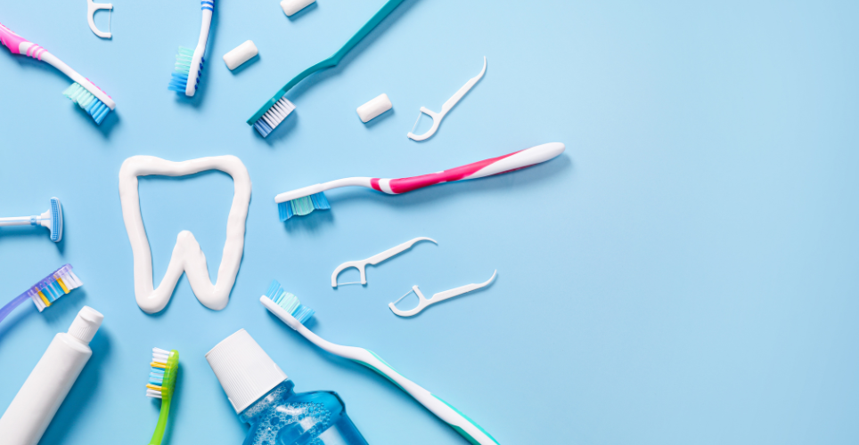 Tooth drawn in toothpaste surround by toothbrushes mouthwash