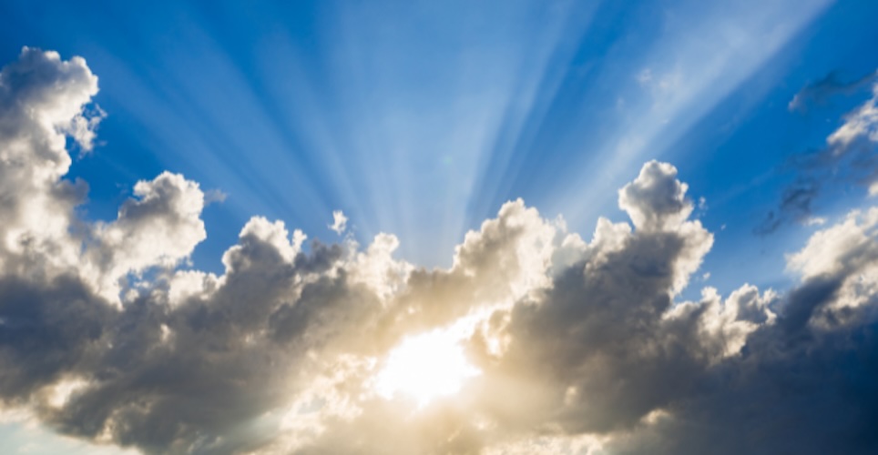 Blue sky with the sun breaking through stormclouds