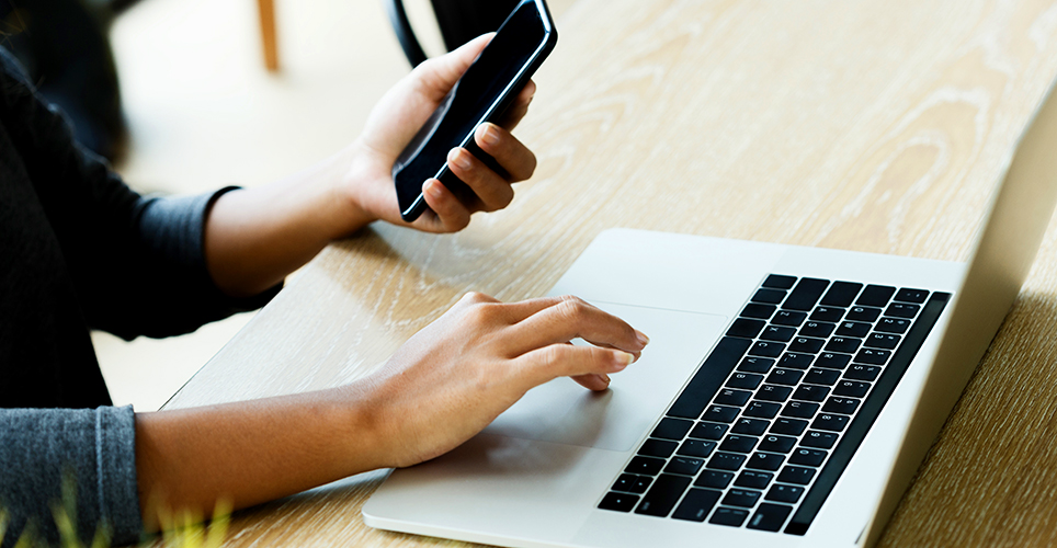 hands with laptop and phone