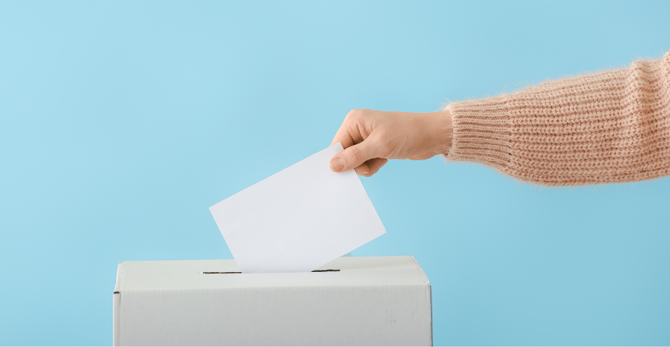 A person casts their ballot to vote.