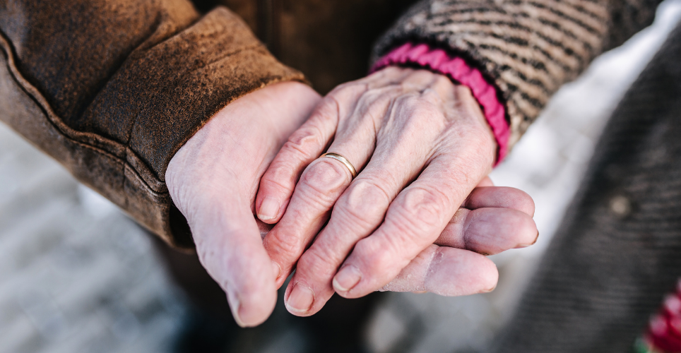 Close up of elderly couple holding hands 