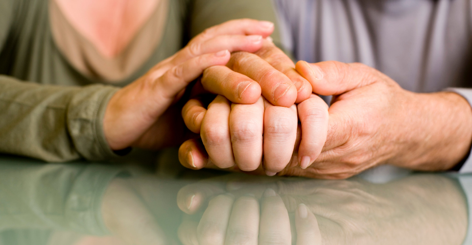 close up of two Caucasian hands holding each other