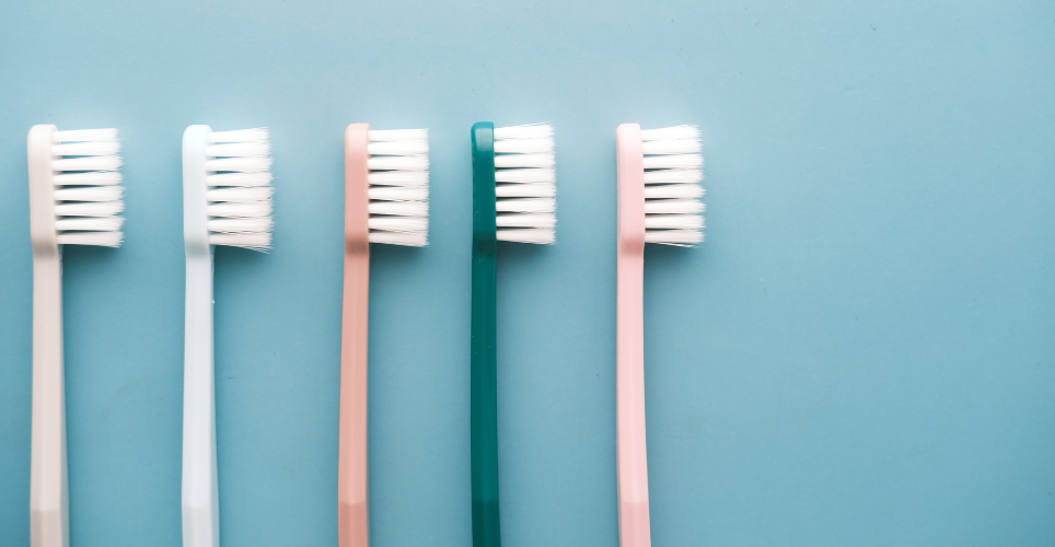 Colorful toothbrushes on a blue background. 