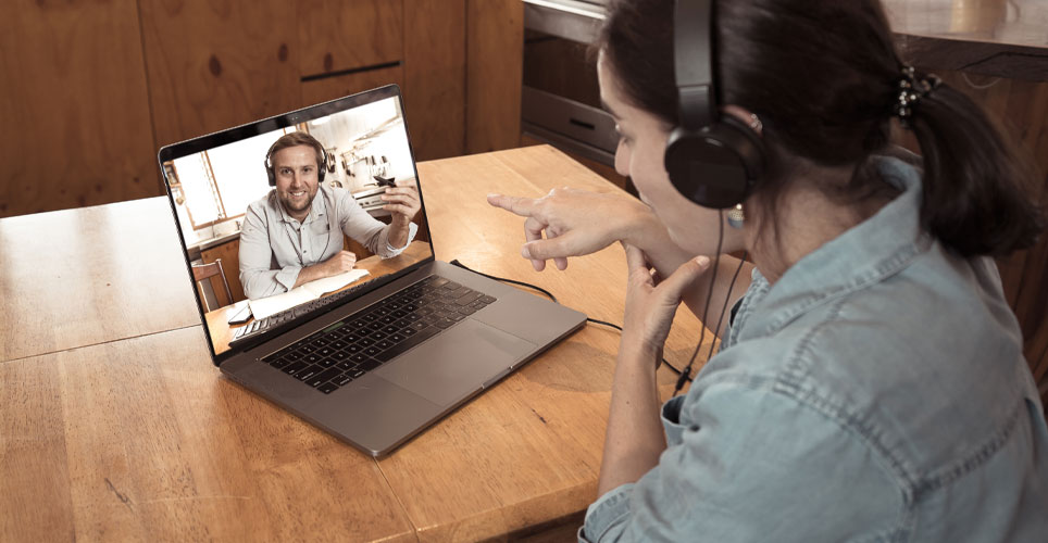 A woman talking to a man via video chat.