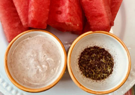 sliced watermelon and 2 bowls with dips