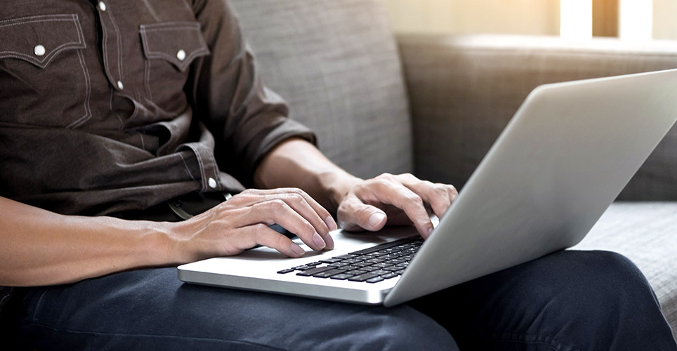 Man typing on laptop 